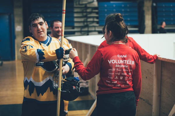 Athlete and volunteer taking a break on the court