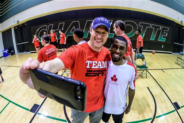 Volunteer and athlete taking a selfie.