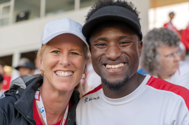 Coach and athlete smiling for the camera.